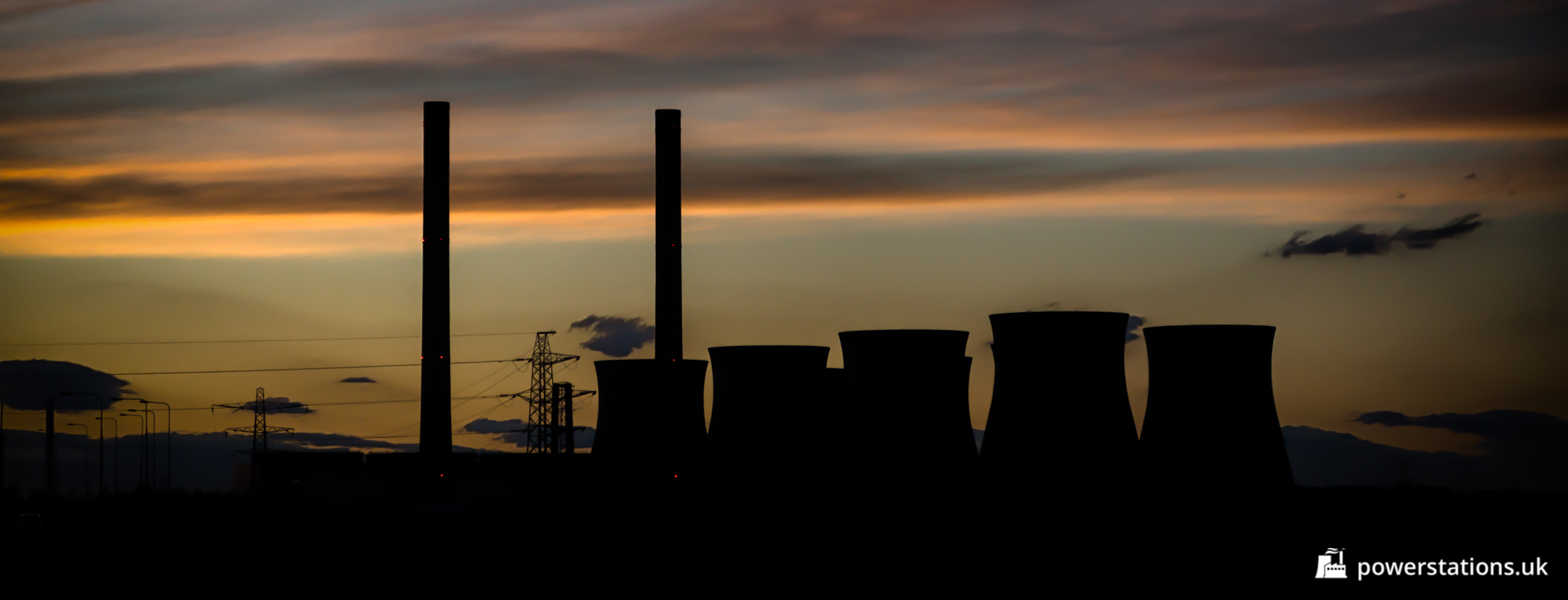 The sun sets behind the dormant Ferrybridge C Power Station